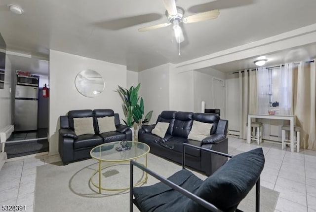 tiled living room featuring baseboard heating and ceiling fan