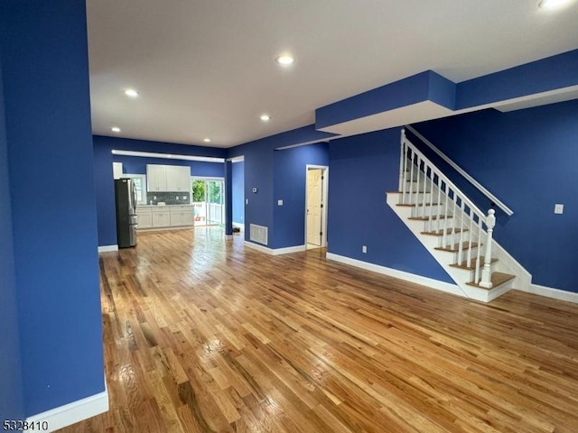 unfurnished living room with hardwood / wood-style floors