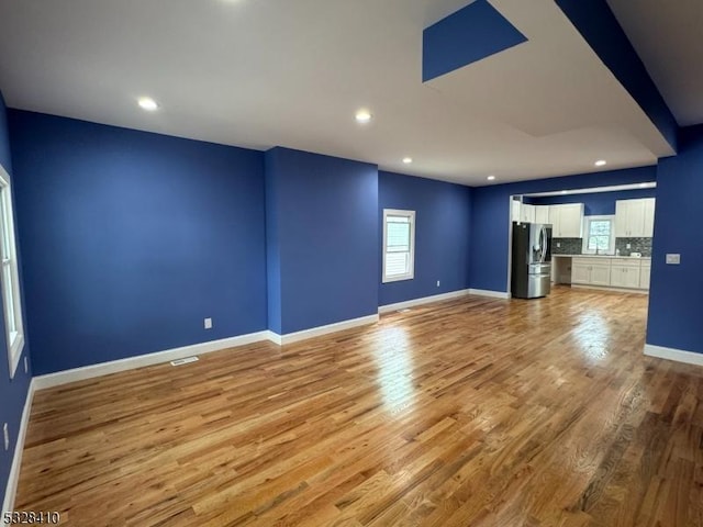 unfurnished living room featuring light wood-type flooring