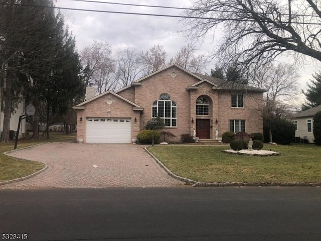 view of front of home with a garage and a front lawn