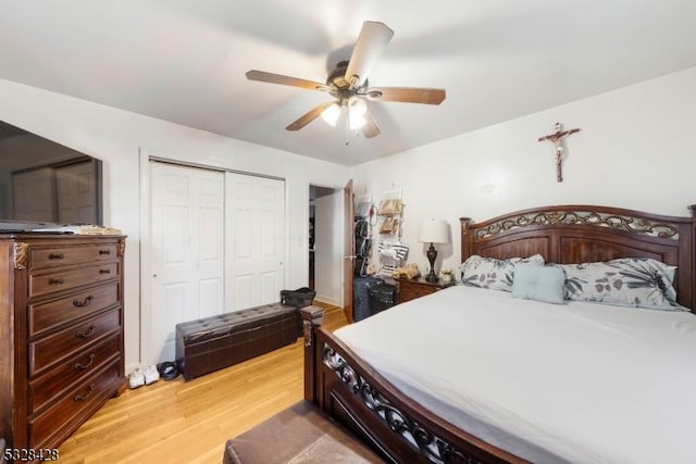 bedroom with ceiling fan, light hardwood / wood-style floors, and a closet