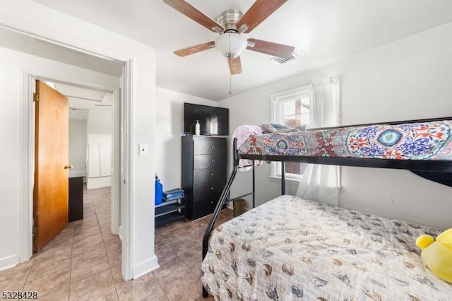 tiled bedroom featuring ceiling fan and a closet