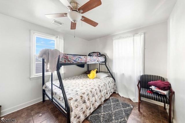 bedroom featuring ceiling fan and dark tile patterned flooring