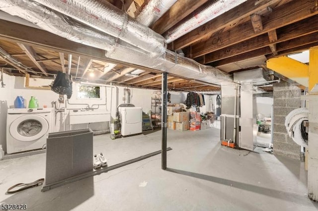 basement featuring washer and clothes dryer and sink