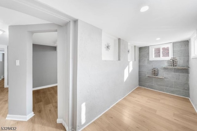 interior space featuring hardwood / wood-style floors and tile walls