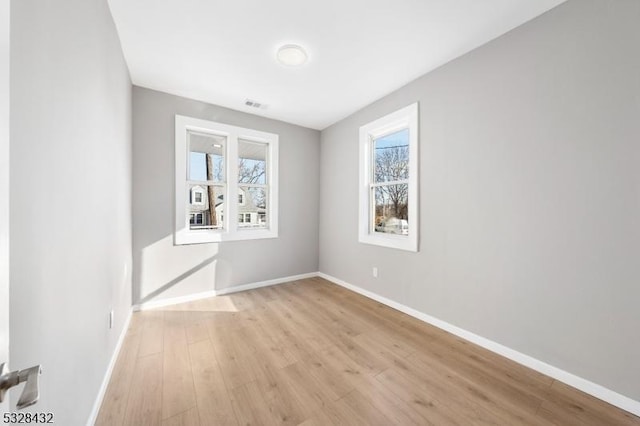 spare room featuring light hardwood / wood-style floors