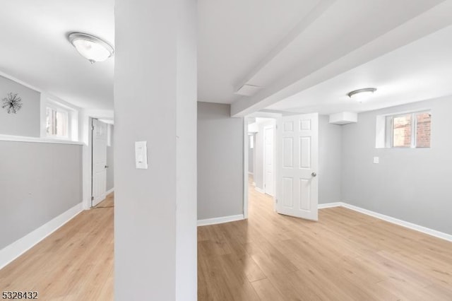 basement with light hardwood / wood-style flooring