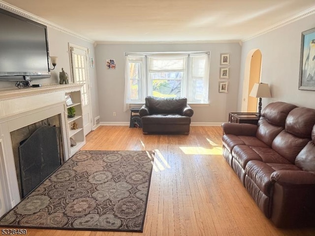 living room with light hardwood / wood-style flooring and crown molding