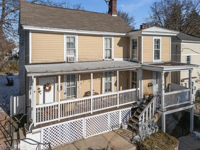 view of front of home featuring cooling unit and covered porch