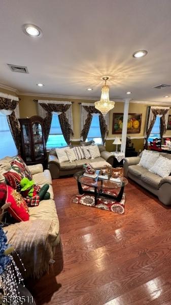 living room featuring ornamental molding and a chandelier