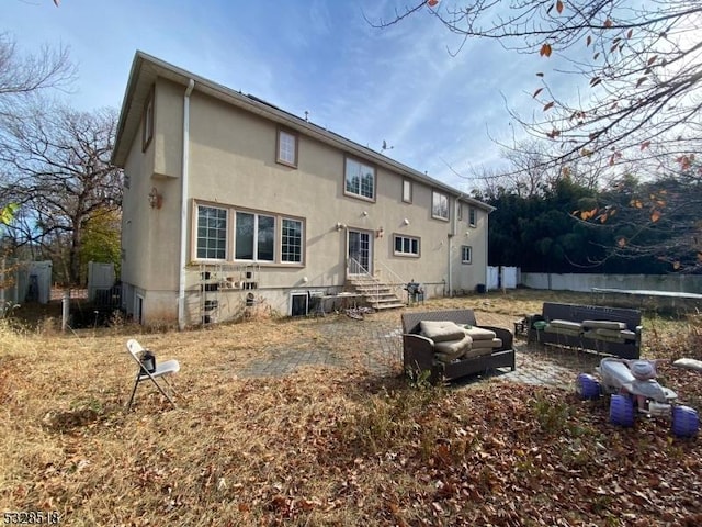 back of house featuring an outdoor living space