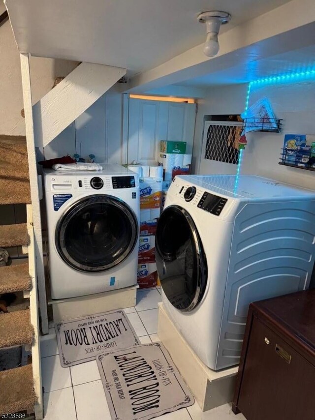 laundry room with light tile patterned flooring and washer and dryer