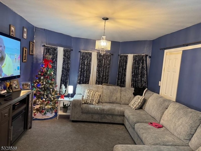 carpeted living room with an inviting chandelier