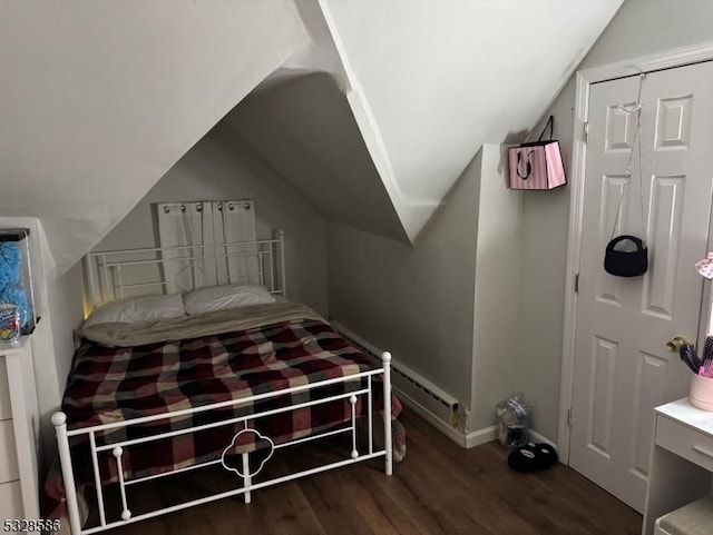 bedroom with dark wood-type flooring and vaulted ceiling