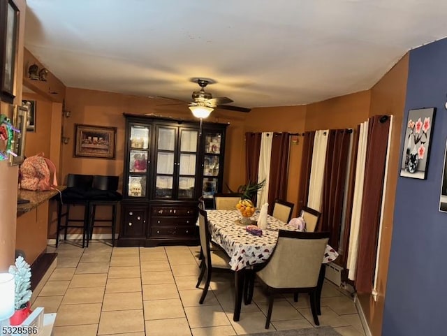 tiled dining room featuring ceiling fan