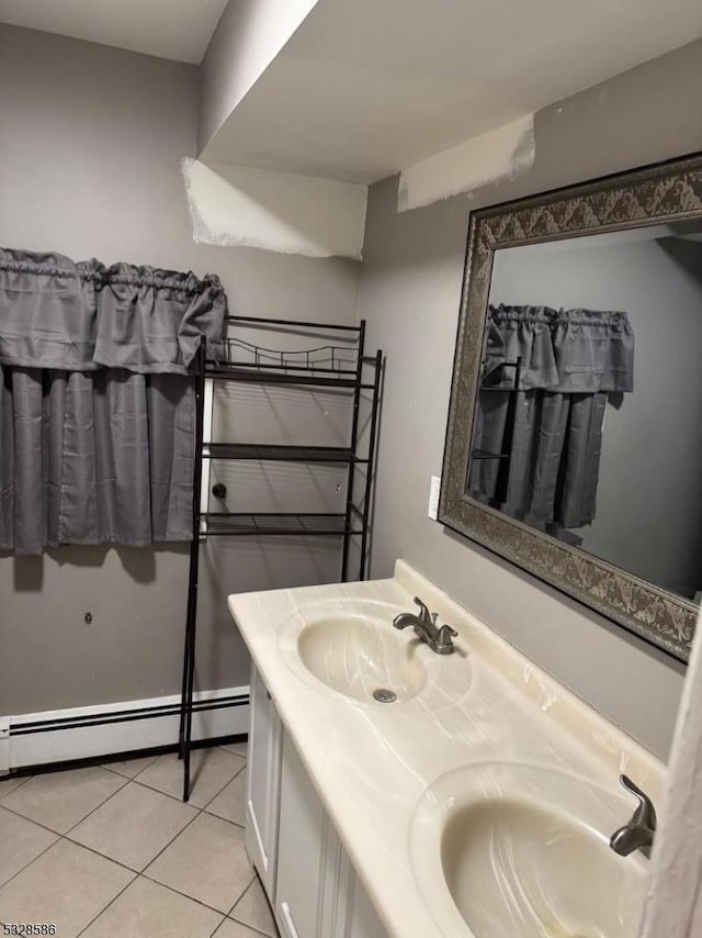 bathroom featuring tile patterned floors, vanity, and a baseboard heating unit