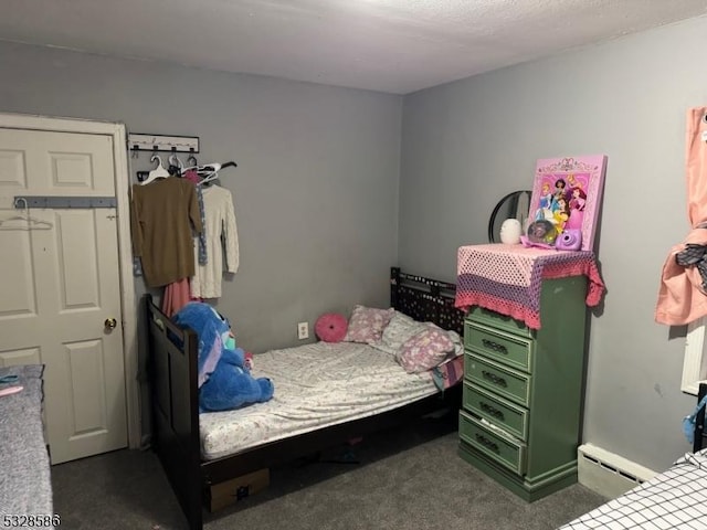 bedroom featuring dark carpet and baseboard heating