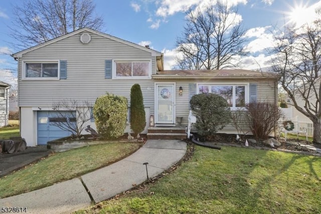 split level home featuring a garage and a front yard