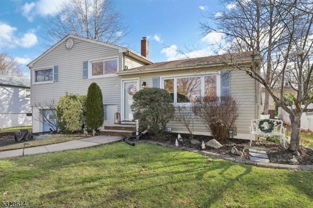 tri-level home with a front yard