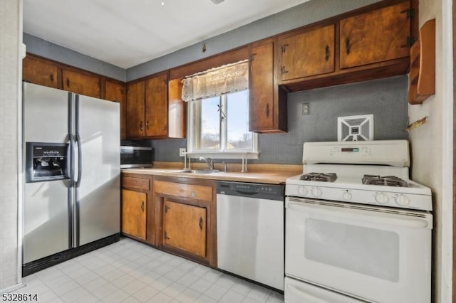 kitchen with sink and appliances with stainless steel finishes