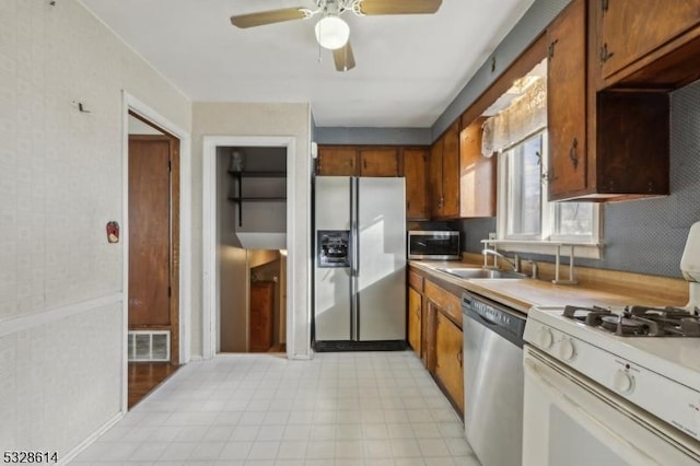 kitchen featuring ceiling fan, sink, and appliances with stainless steel finishes