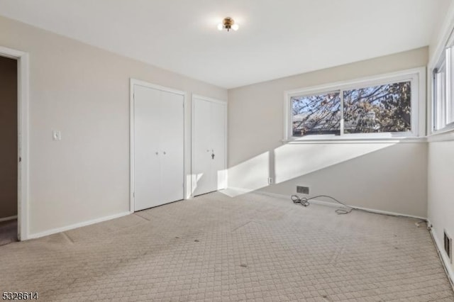 unfurnished bedroom featuring light colored carpet