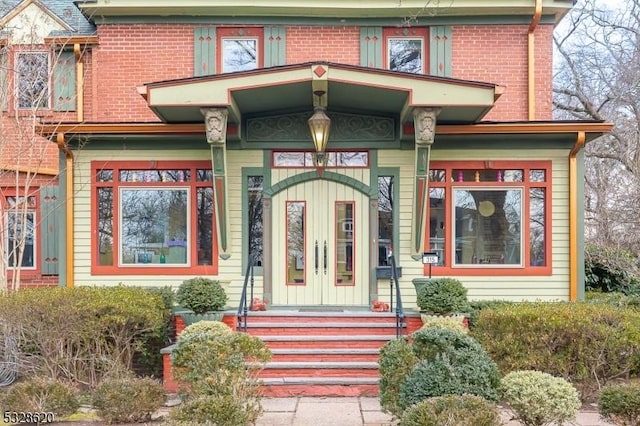 entrance to property featuring brick siding