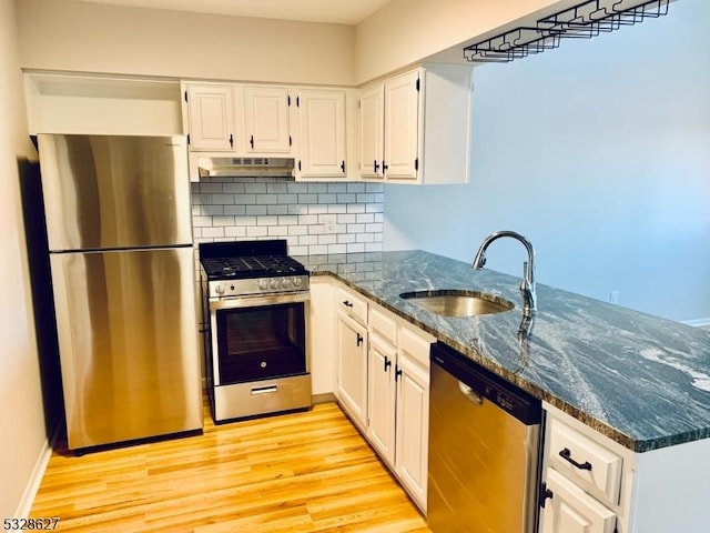 kitchen featuring white cabinets, appliances with stainless steel finishes, and sink