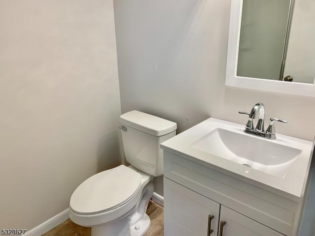 bathroom featuring tile patterned floors, vanity, and toilet