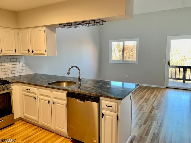 kitchen featuring a wealth of natural light, white cabinetry, and appliances with stainless steel finishes