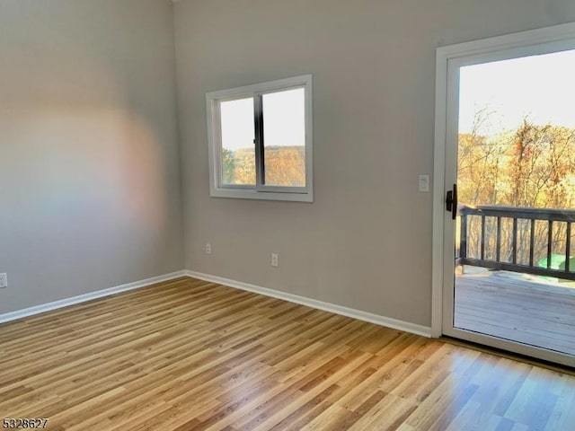 unfurnished room with light wood-type flooring