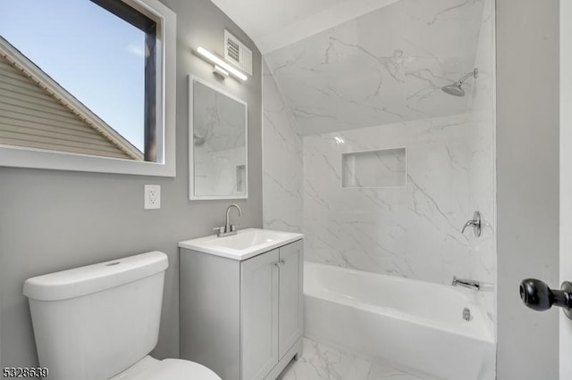 full bathroom featuring toilet, vanity, and tiled shower / bath combo