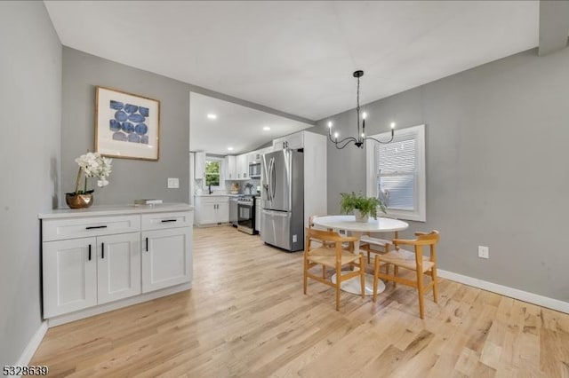 dining room featuring light hardwood / wood-style floors and an inviting chandelier