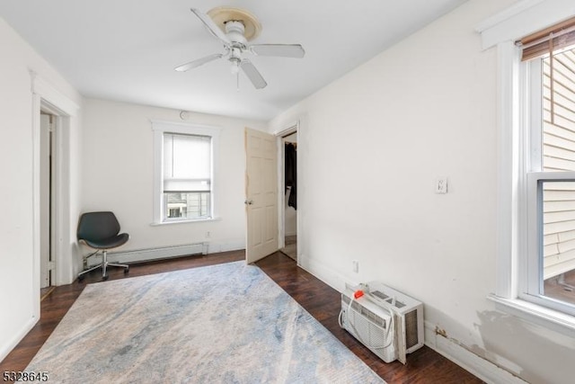 bedroom featuring a wall mounted AC, ceiling fan, a baseboard radiator, and dark hardwood / wood-style floors