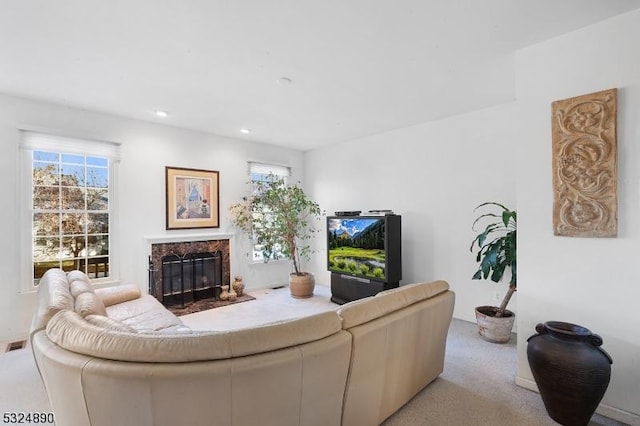 carpeted living room featuring a fireplace