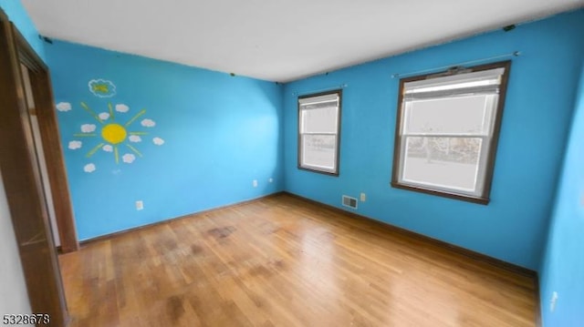 spare room featuring hardwood / wood-style flooring