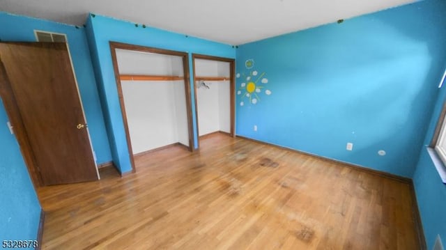 unfurnished bedroom with wood-type flooring