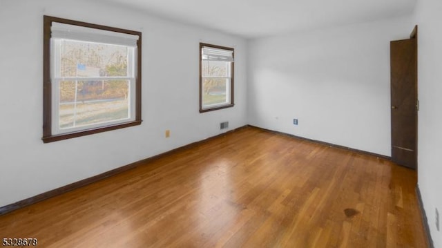 spare room with hardwood / wood-style floors