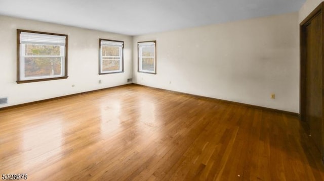 unfurnished room featuring hardwood / wood-style floors