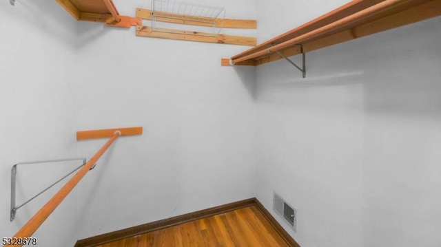 walk in closet featuring hardwood / wood-style flooring