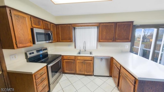 kitchen with light tile patterned flooring, sink, and appliances with stainless steel finishes