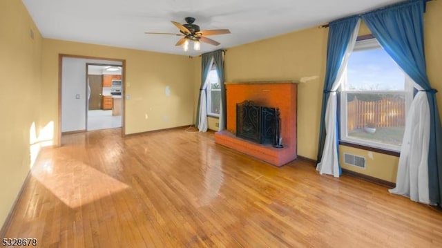 unfurnished living room featuring ceiling fan and light hardwood / wood-style flooring