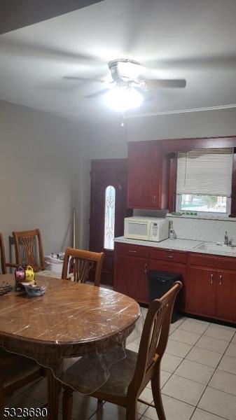 dining space with light tile patterned floors, a healthy amount of sunlight, and sink