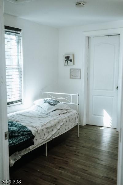 bedroom featuring dark wood-style floors