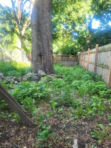 82 Palm St, Newark City, NJ 07106 - fenced backyard featuring a vegetable garden