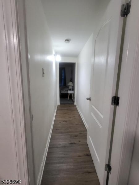 82 Palm St, Newark City, NJ 07106 - hall with baseboards and dark wood-style floors
