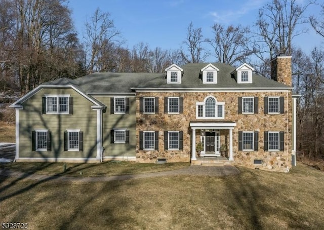 colonial home with a front lawn