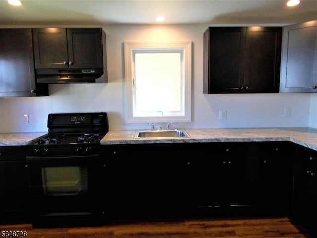 kitchen with black gas range, dark hardwood / wood-style flooring, and sink