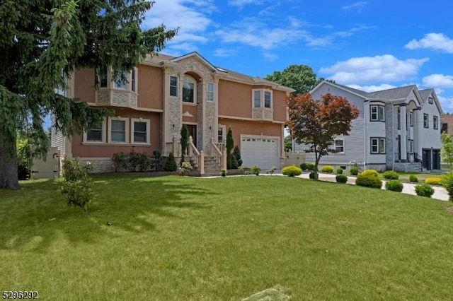 view of front of home with a front yard and a garage