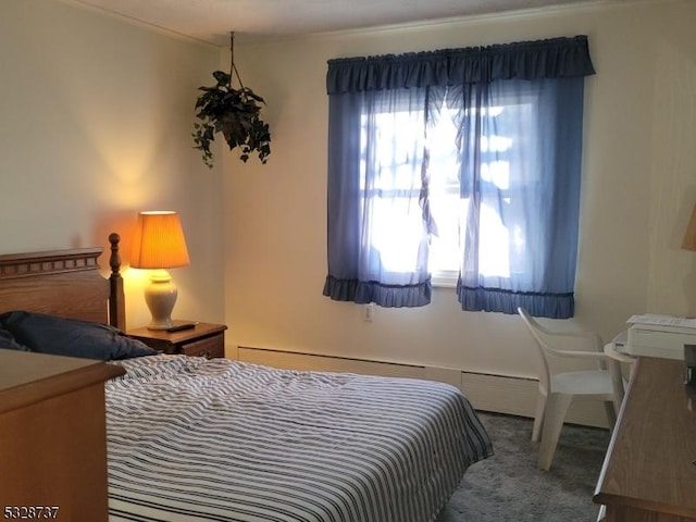 carpeted bedroom featuring a baseboard heating unit